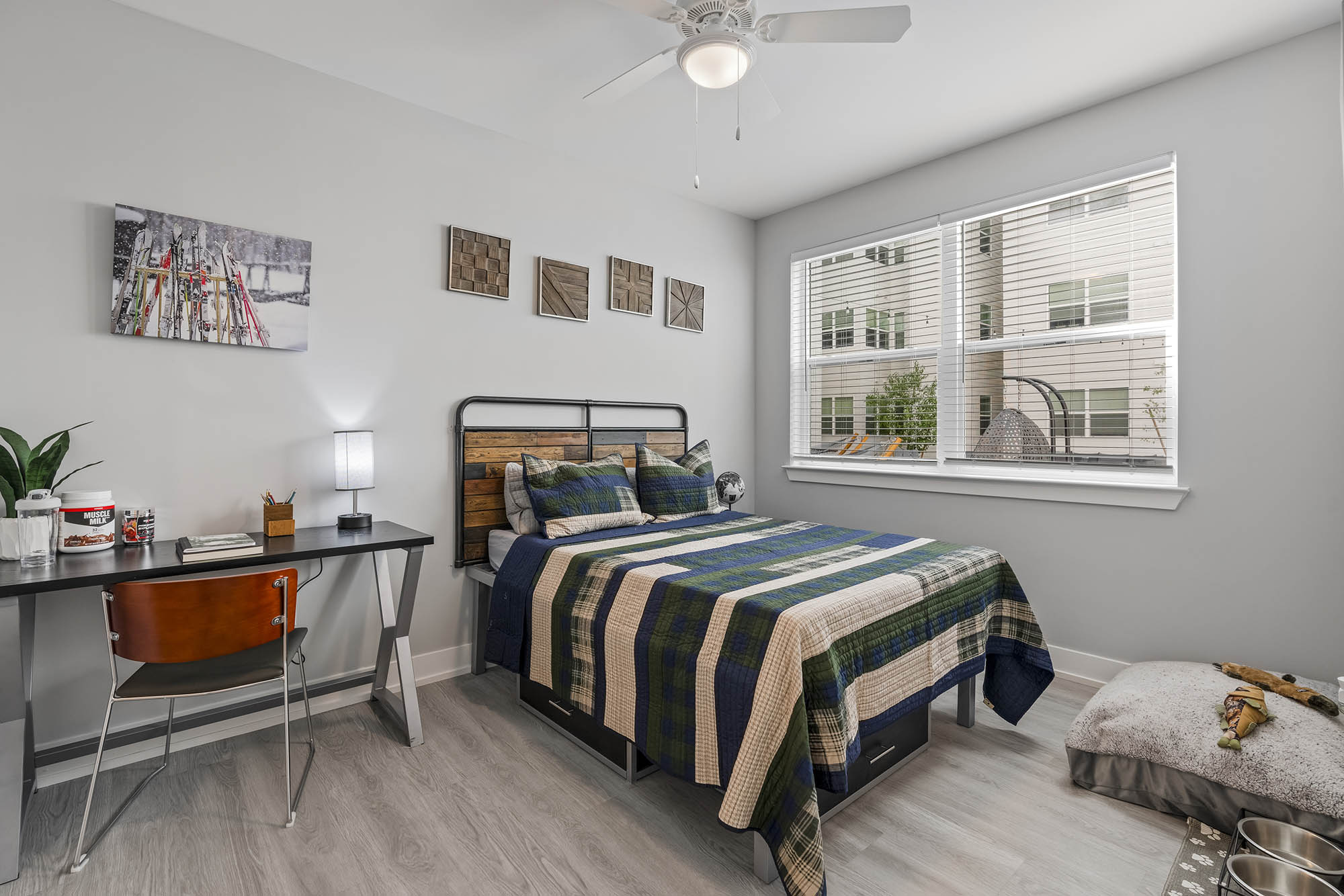 Cozy bedroom with a bed desk and large windows