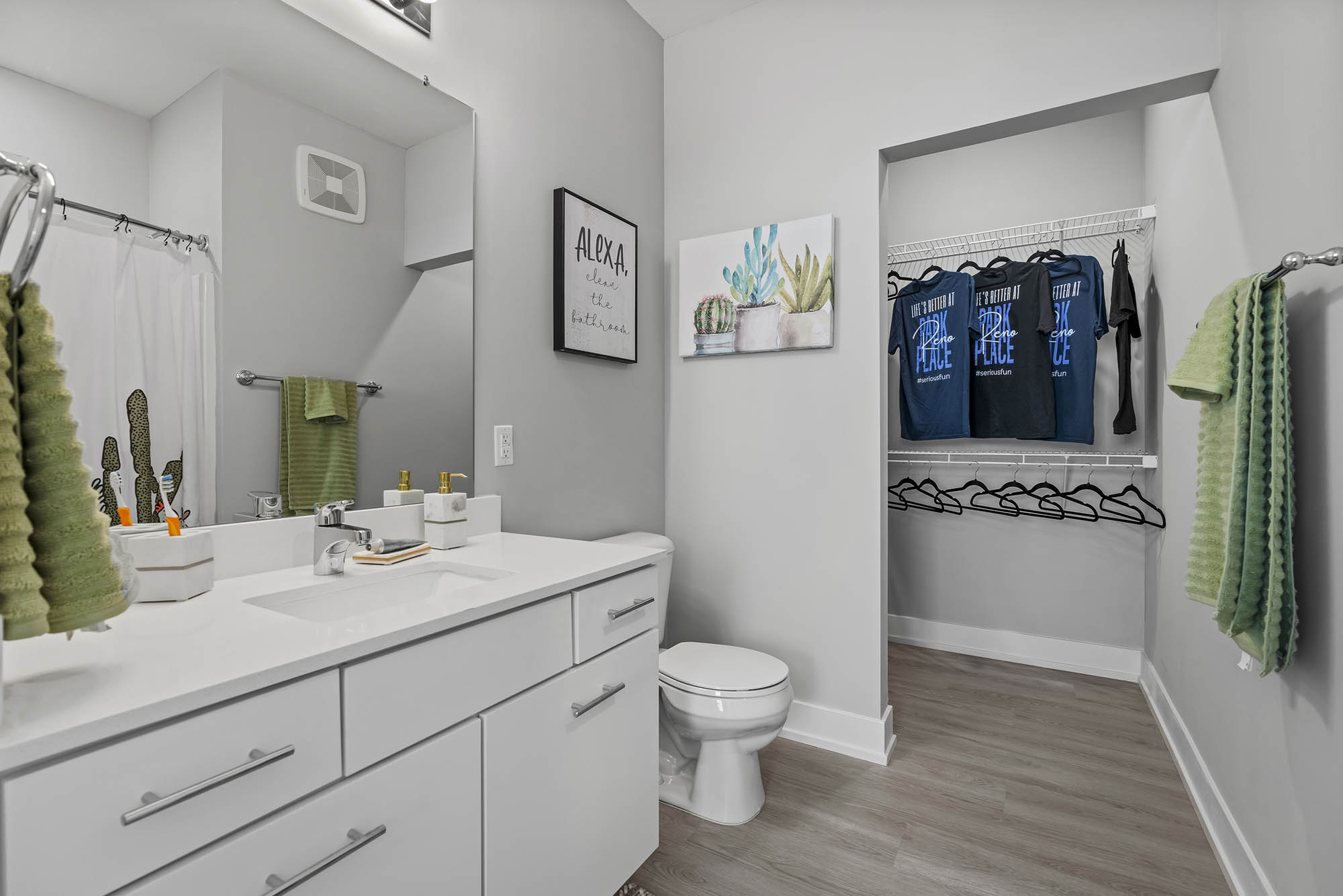 Modern bathroom with a sink towels and clothes in a closet
