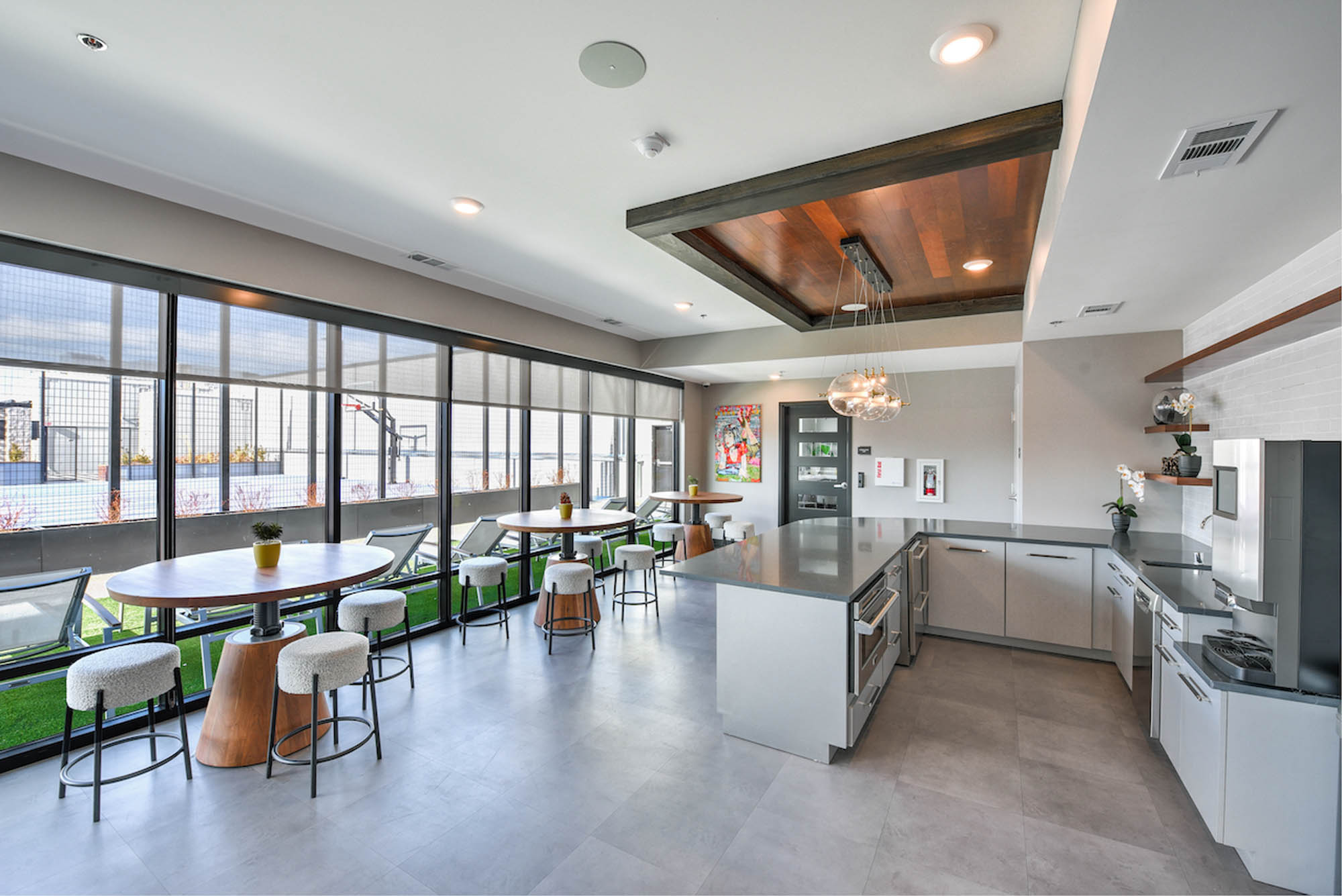 Modern kitchen and dining area with large windows featuring elegant furnishings