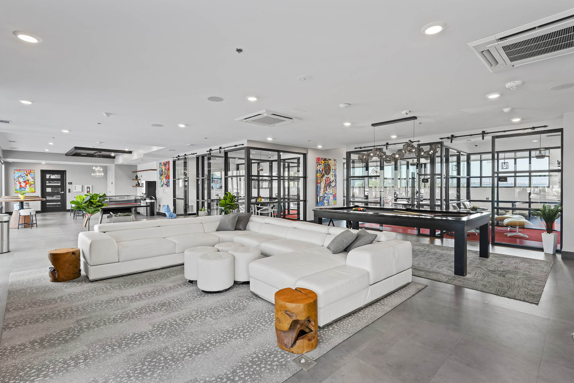 Modern lounge area with white furniture and colorful artwork