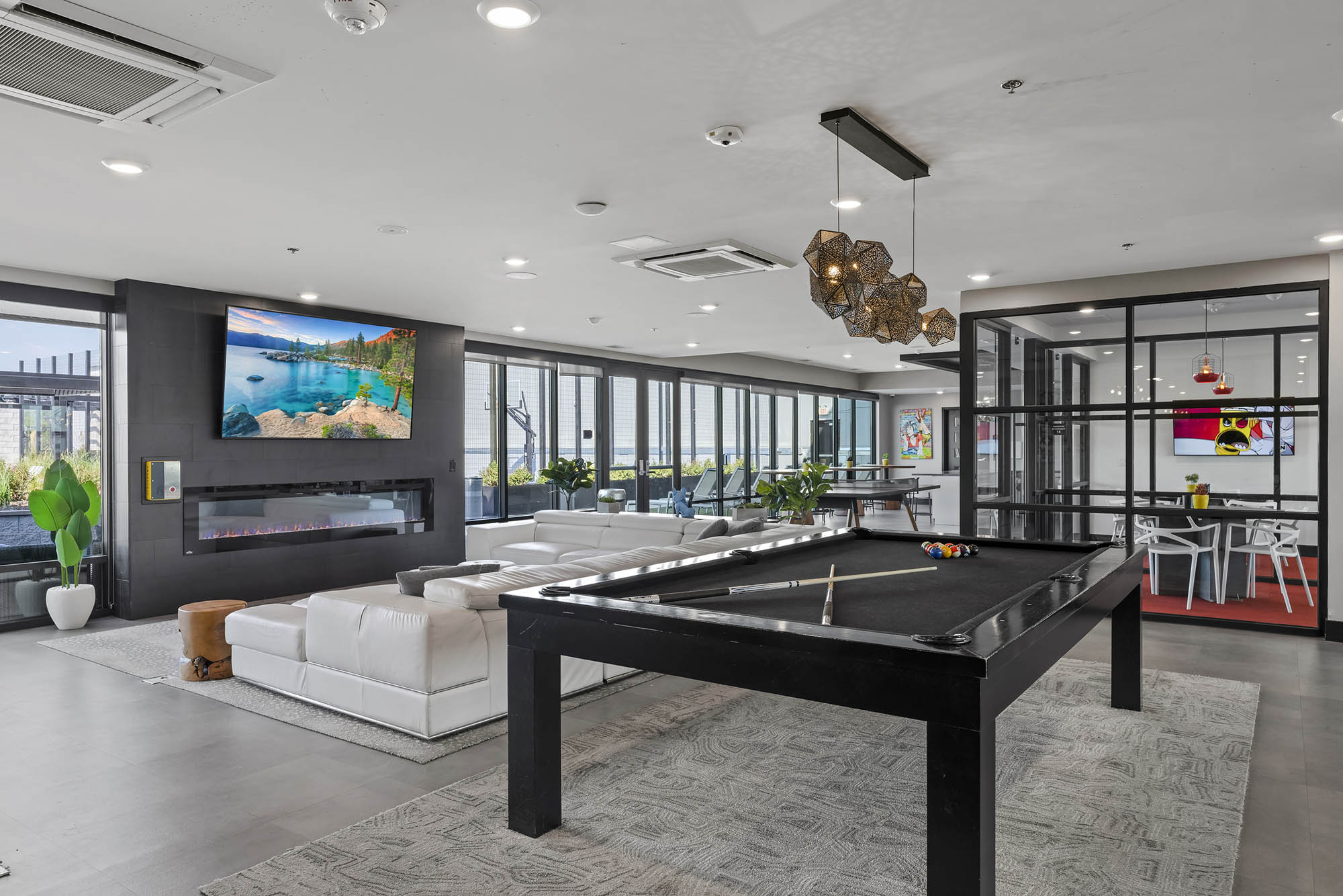 Modern lounge with pool table TV and seating area