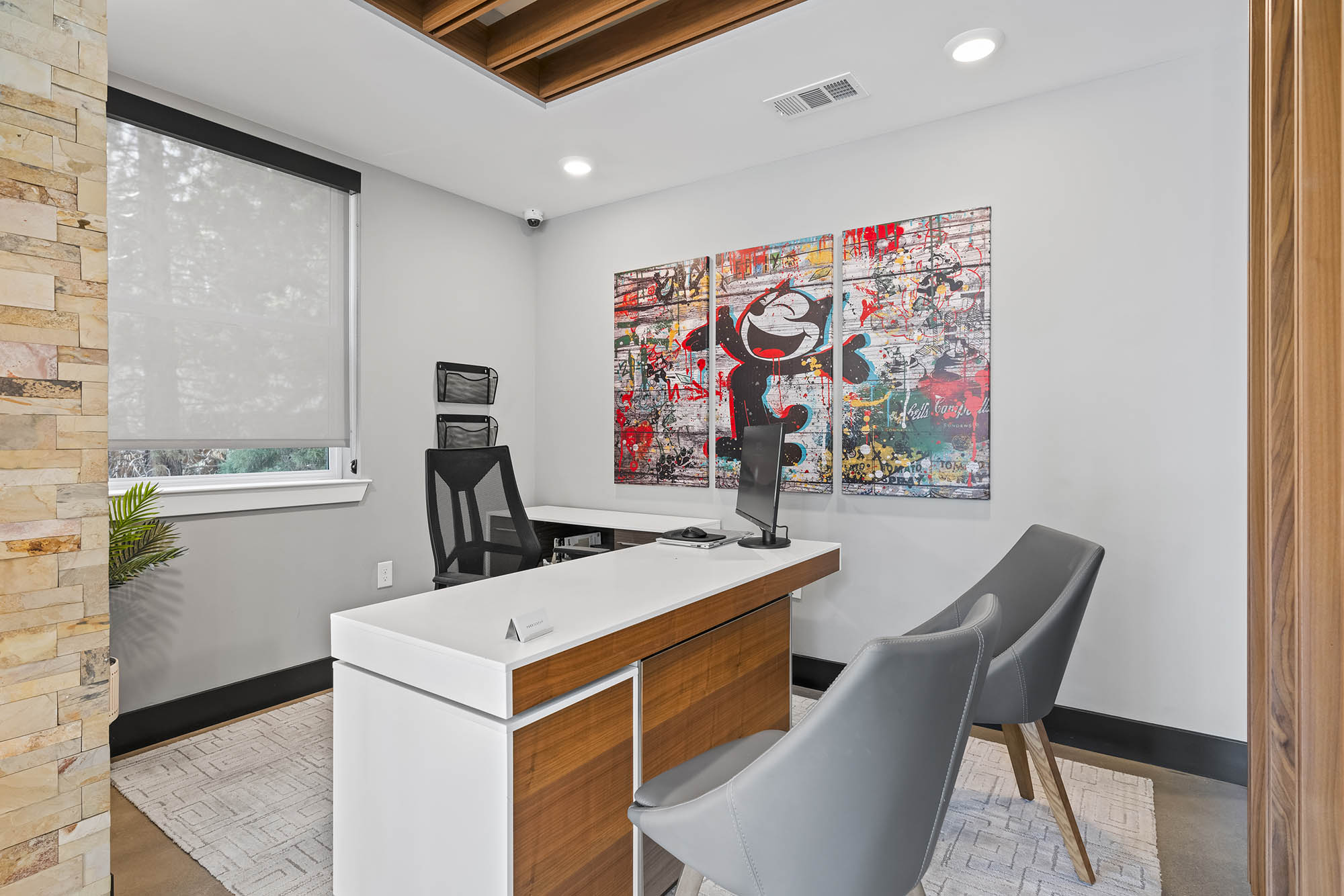 Modern office space with desk chairs and colorful artwork