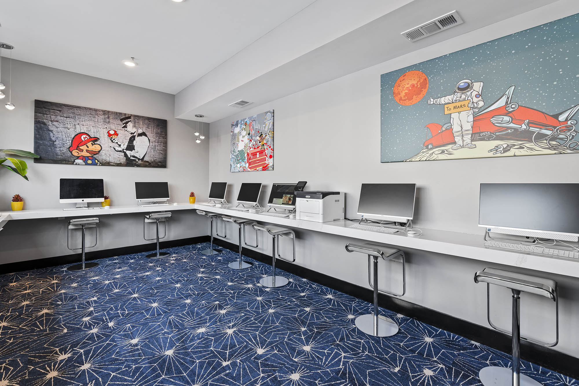 a modern workspace featuring several computers vi