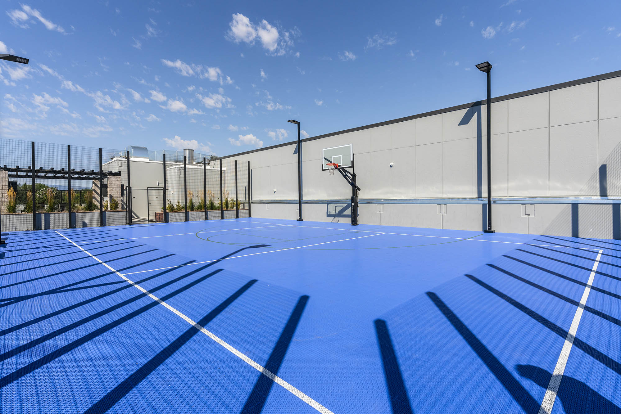 bright blue basketball court with a hoop surround