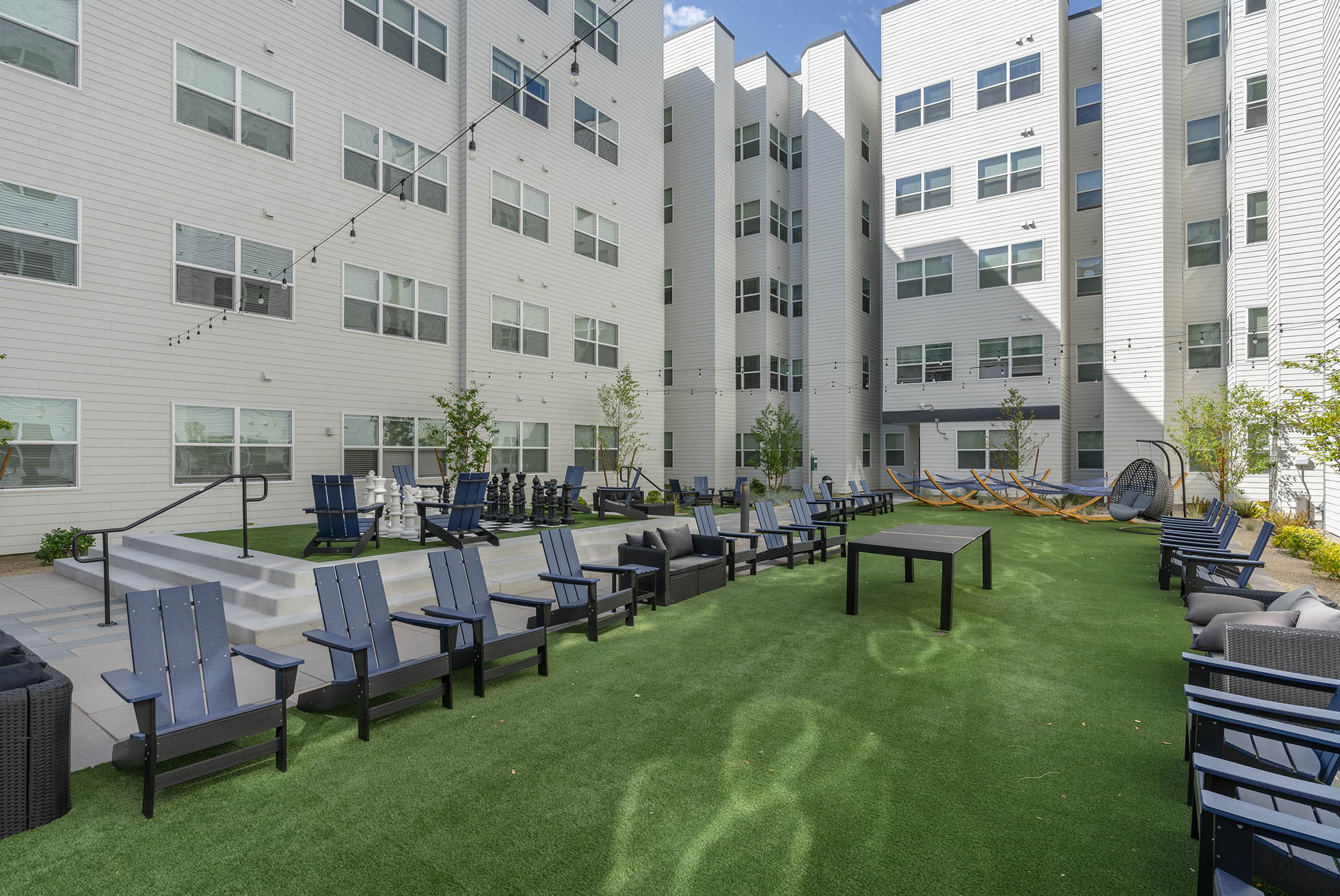 modern courtyard with seating greenery hammocks