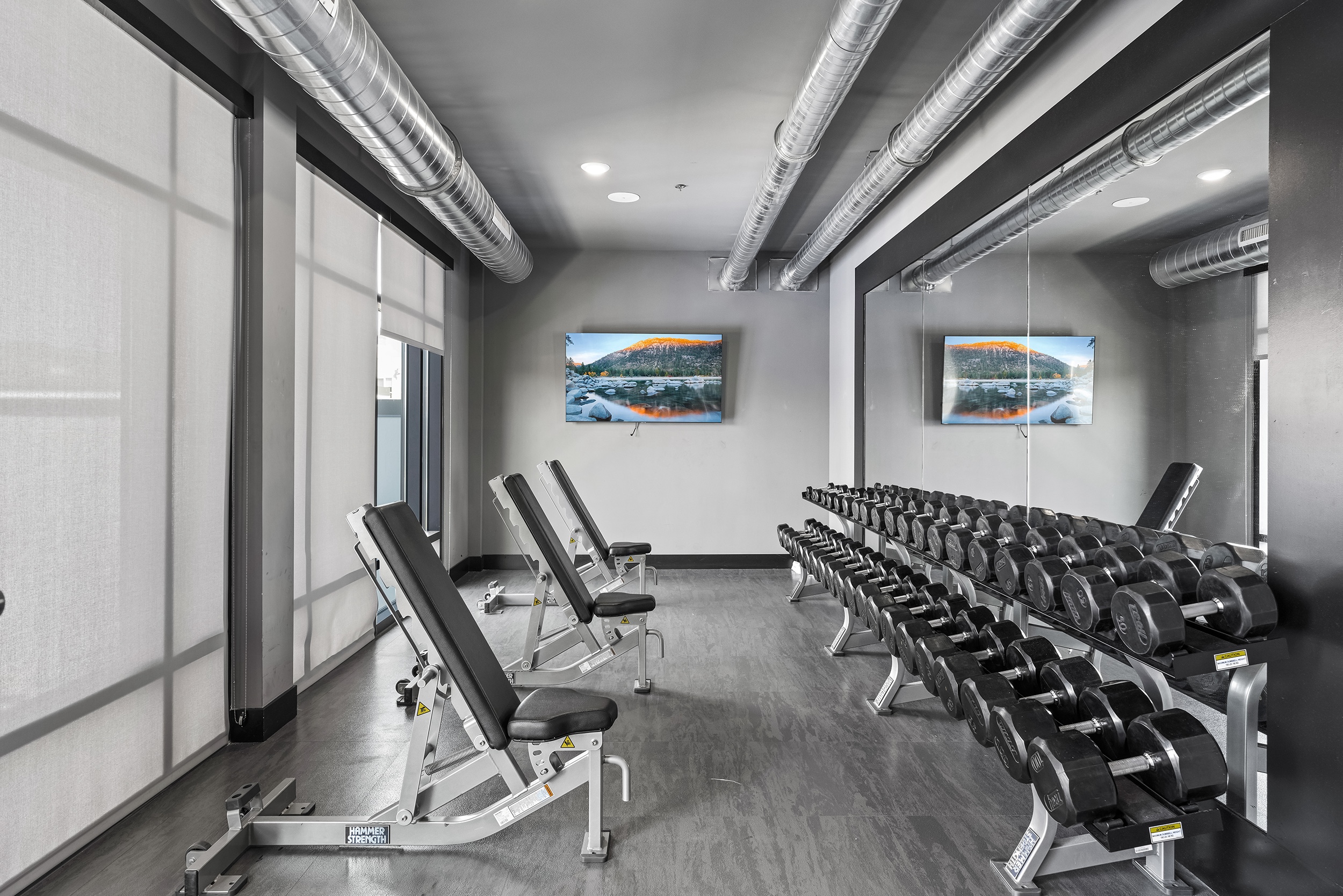modern gym area featuring adjustable benches a ra
