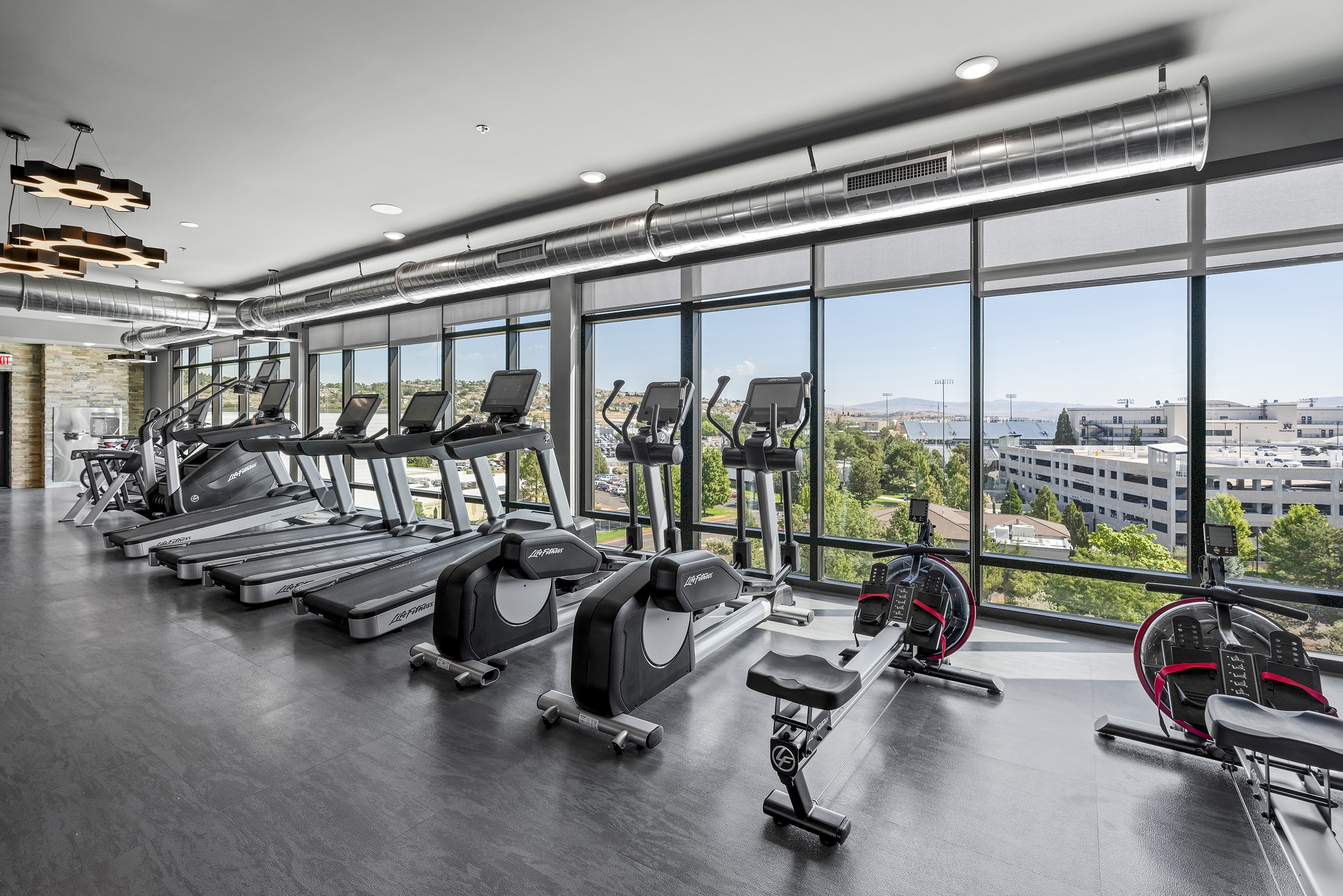 modern gym interior featuring treadmills elliptic