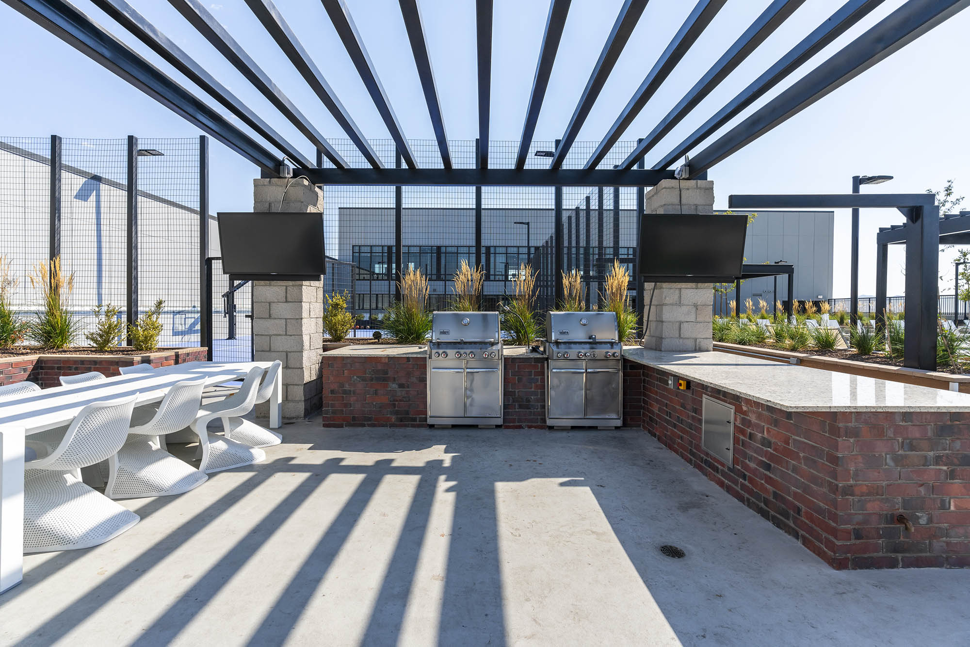 outdoor grilling area with two stainless steel gri