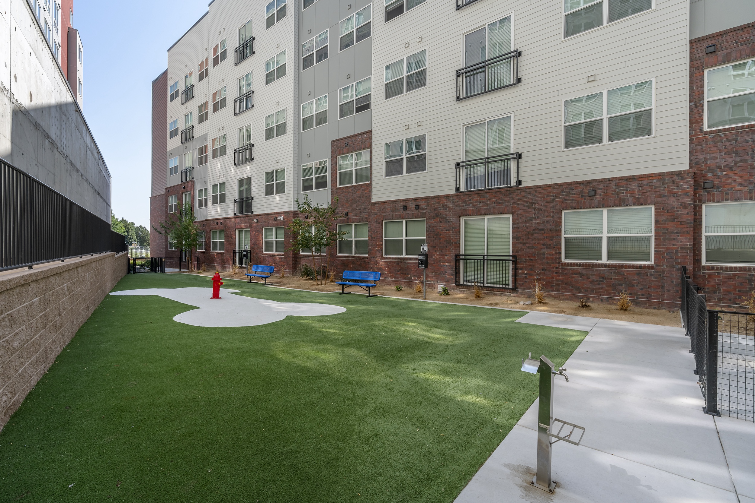 urban outdoor space with synthetic grass a red fi